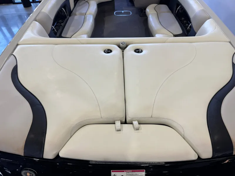 Slide: The Image of Interior of a 2006 Malibu 247 LSV boat with beige seating. - 10