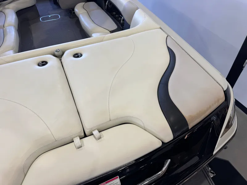 Slide: The Image of Interior of a 2006 Malibu 247 LSV boat with beige seating. - 11