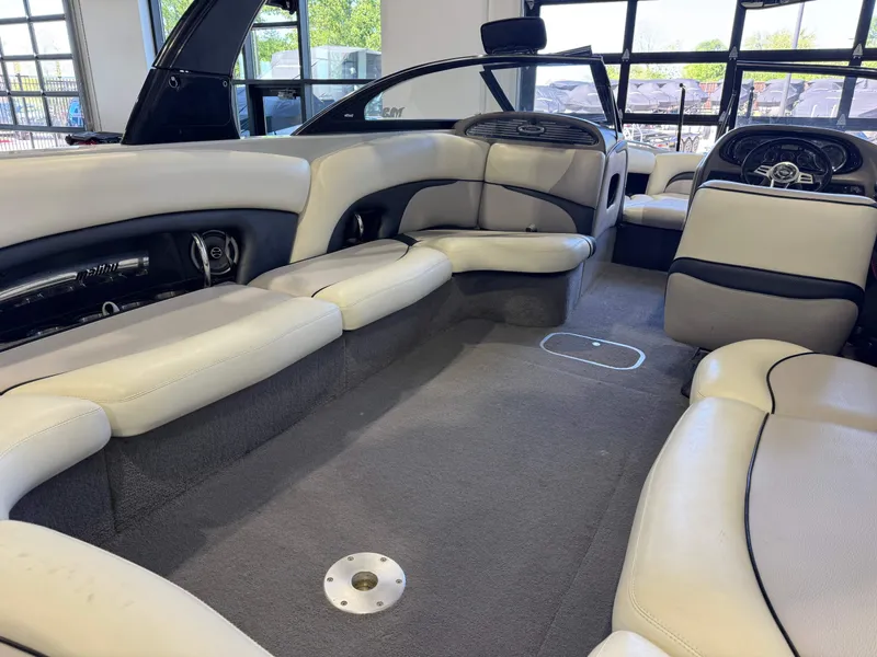 Slide: The Image of Interior of a 2006 Malibu 247 LSV boat with beige seating. - 14