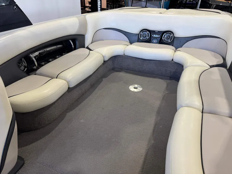 Slide: The Image of Interior of a 2006 Malibu 247 LSV boat with beige seating. - 15