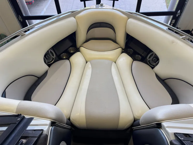 Slide: The Image of Interior of a 2006 Malibu 247 LSV boat with beige seating. - 17