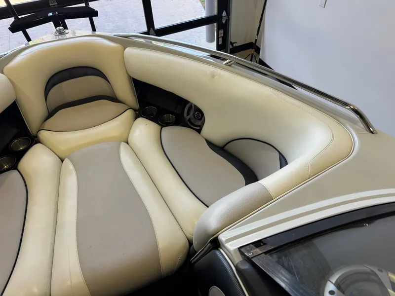 Slide: The Image of Interior of a 2006 Malibu 247 LSV boat with beige seating. - 18