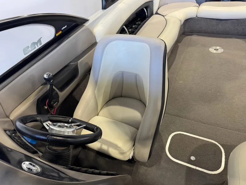 Slide: The Image of Interior of a 2006 Malibu 247 LSV boat with steering wheel and seat. - 21