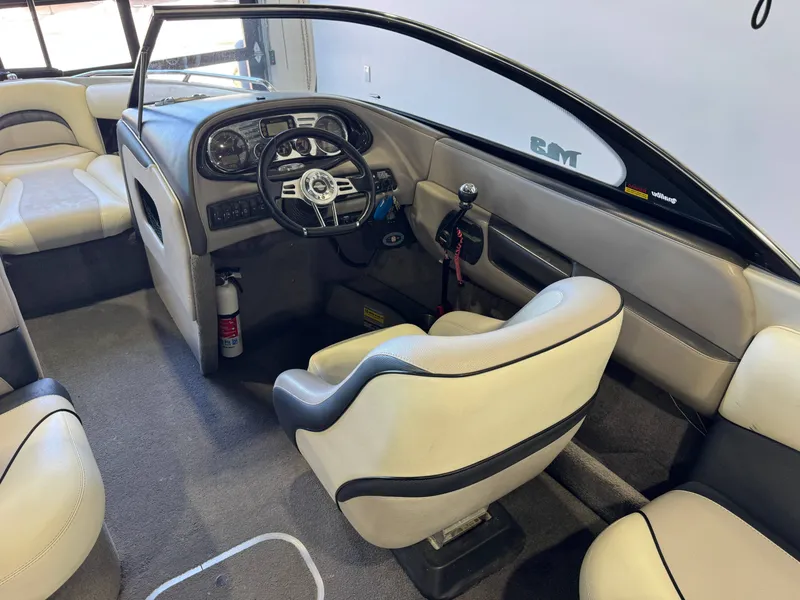 Slide: The Image of Interior of a 2006 Malibu 247 LSV boat with steering console. - 23