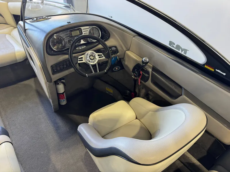 Slide: The Image of Interior of a 2006 Malibu 247 LSV boat with steering console. - 24