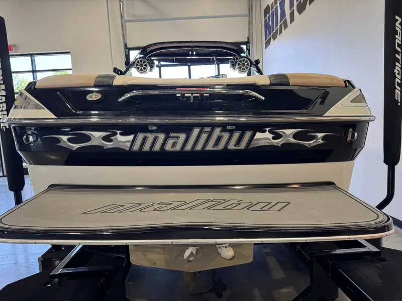 Slide: The Image of Rear view of a 2006 Malibu 247 LSV boat in a garage. - 6