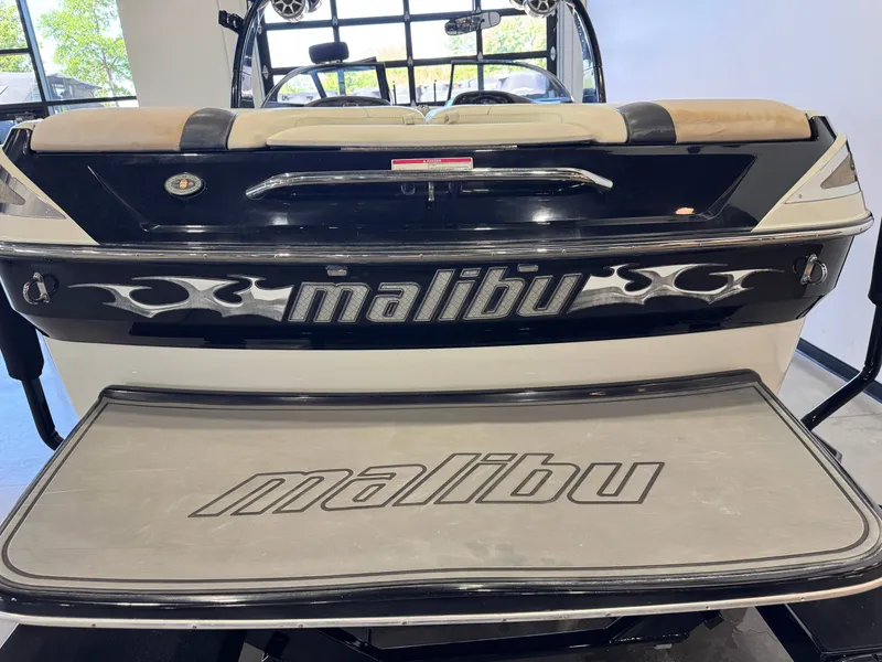 Slide: The Image of Rear view of a 2006 Malibu 247 LSV boat indoors. - 8