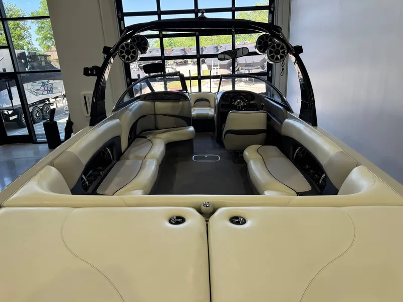 Slide: The Image of Interior of a 2006 Malibu 247 LSV boat with beige seating. - 9