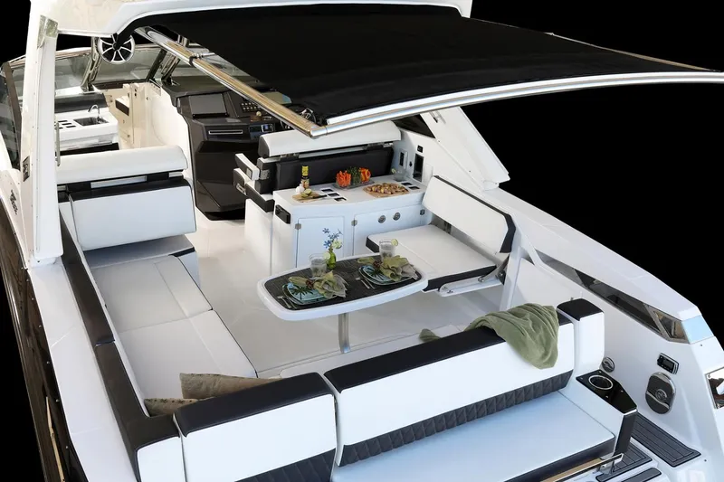 Slide: The Image of Manufacturer Provided Image: 2025 Monterey 385SS Super Sport luxury boat interior with sleek seating and dining area. - 6