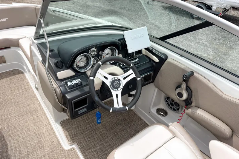 Slide: The Image of 2018 Crownline Eclipse E215 XS boat dashboard with steering wheel and controls. - 12