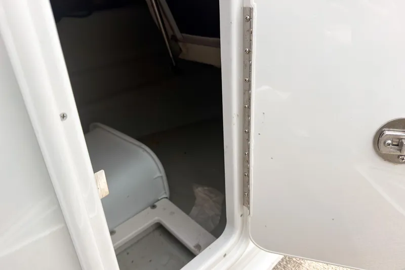 Slide: The Image of Open storage compartment on a 2018 Crownline Eclipse E215 XS boat. - 16