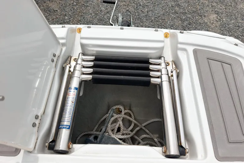 Slide: The Image of 2018 Crownline Eclipse E215 XS boat ladder and storage compartment with ropes. - 18