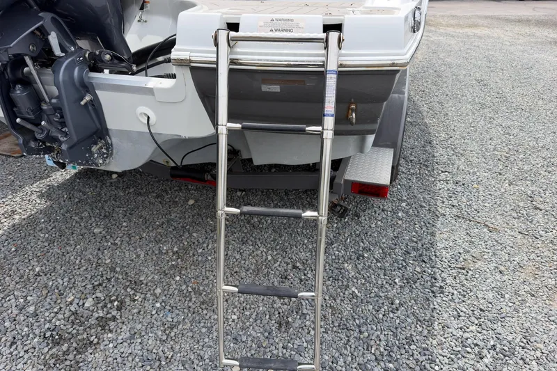 Slide: The Image of Rear view of 2018 Crownline Eclipse E215 XS with extended swim ladder. - 19