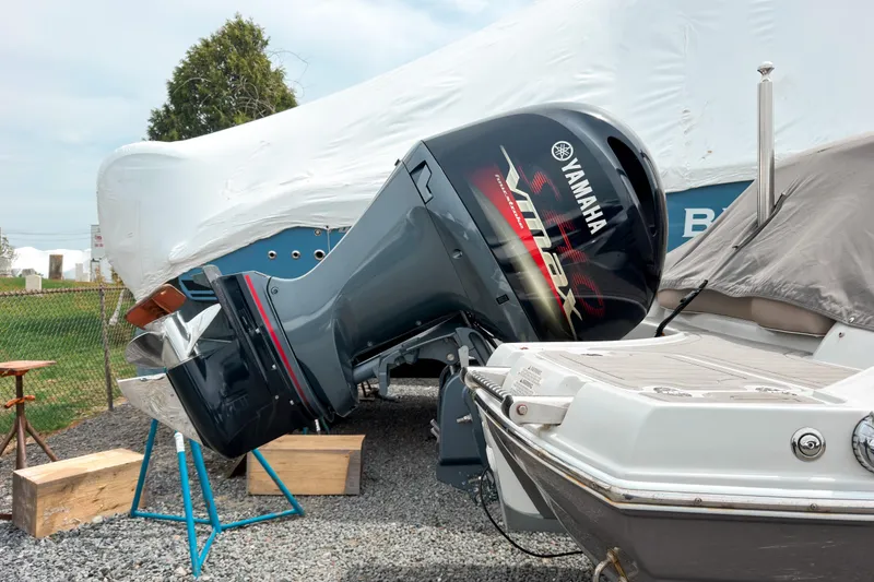 Slide: The Image of 2018 Crownline Eclipse E215 XS with Yamaha VMAX outboard motor, parked outdoors. - 2