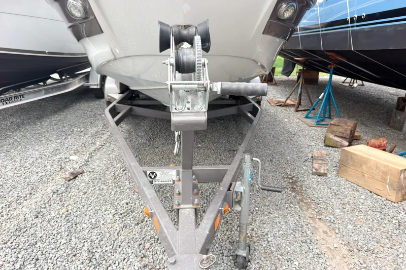 Slide: The Image of 2018 Crownline Eclipse E215 XS boat on trailer, parked on gravel. - 20