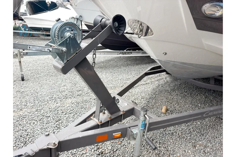 Slide: The Image of Trailer hitch of a 2018 Crownline Eclipse E215 XS boat on gravel. - 21