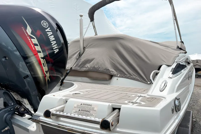 Slide: The Image of 2018 Crownline Eclipse E215 XS boat with Yamaha VMAX engine, covered and docked. - 3