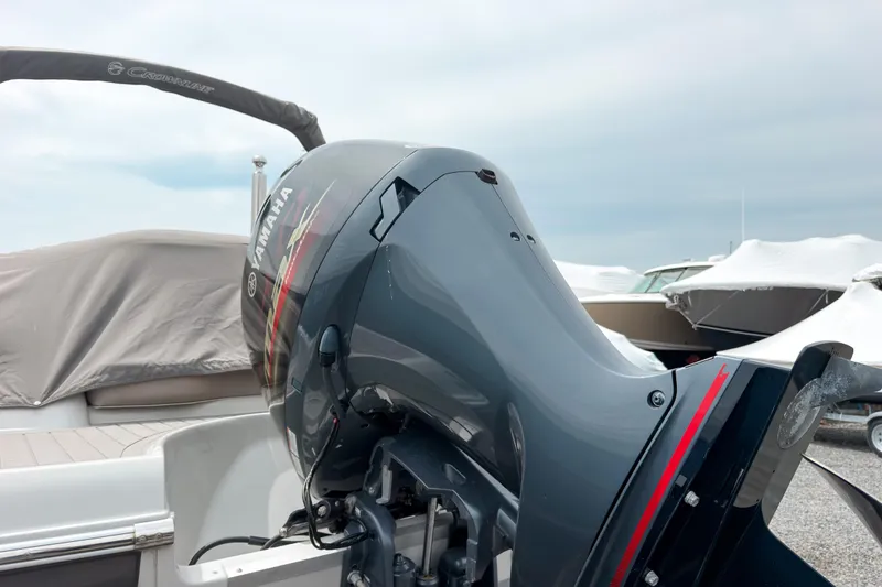 Slide: The Image of 2018 Crownline Eclipse E215 XS with Yamaha outboard motor in a marina setting. - 4