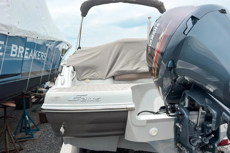 Slide: The Image of 2018 Crownline Eclipse E215 XS boat with Yamaha outboard motor, docked and covered. - 5