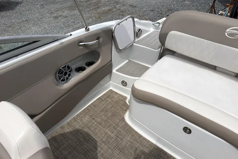 Slide: The Image of Interior of 2018 Crownline Eclipse E215 XS boat with beige seating and speaker system. - 8