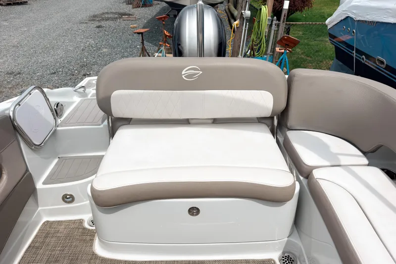 Slide: The Image of 2018 Crownline Eclipse E215 XS boat interior with beige and white seating. - 9