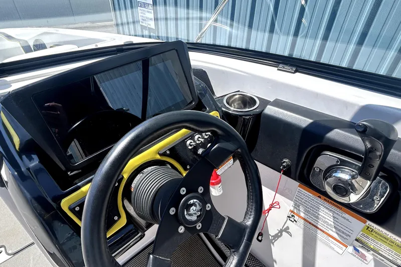 Slide: The Image of 2017 Scarab 255 H.O. Impulse boat dashboard with steering wheel and controls. - 10