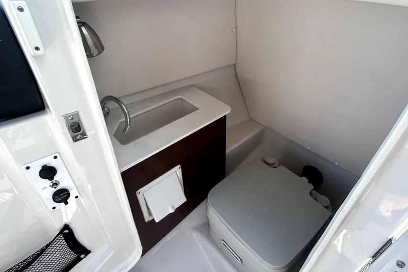 Slide: The Image of 2017 Scarab 255 H.O. Impulse boat interior with sink and portable toilet. - 17