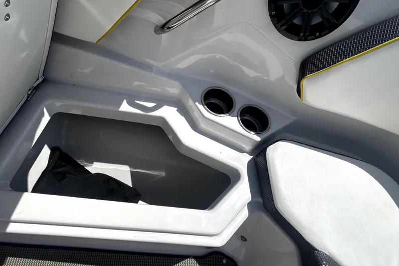 Slide: The Image of Interior storage compartment of 2017 Scarab 255 H.O. Impulse boat with cup holders. - 18