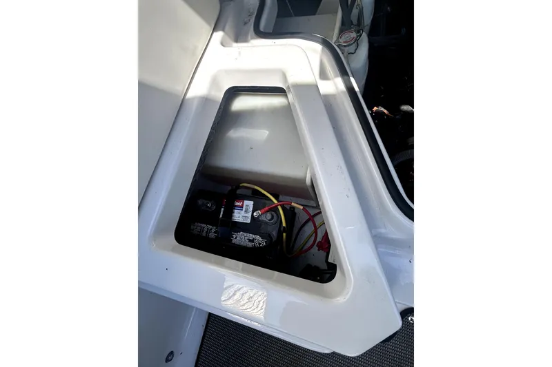 Slide: The Image of Battery compartment of 2017 Scarab 255 H.O. Impulse boat, showing wiring and connections. - 27