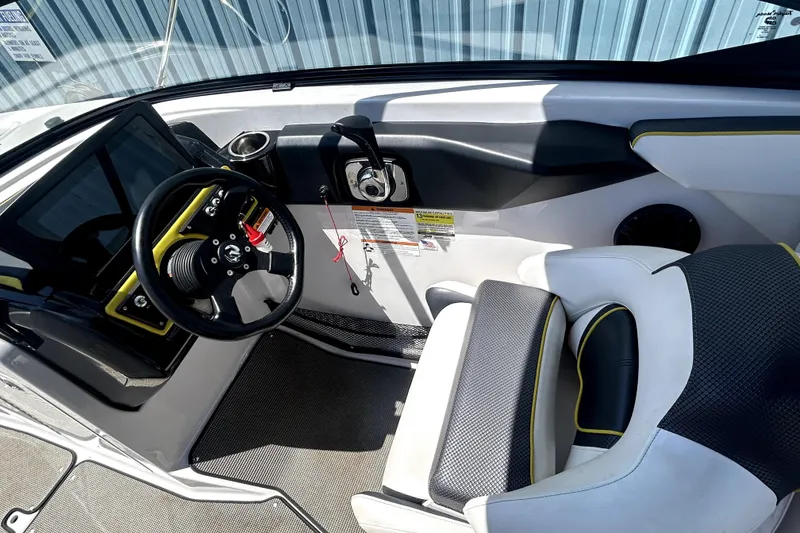 Slide: The Image of 2017 Scarab 255 H.O. Impulse boat interior with steering wheel and seating. - 9