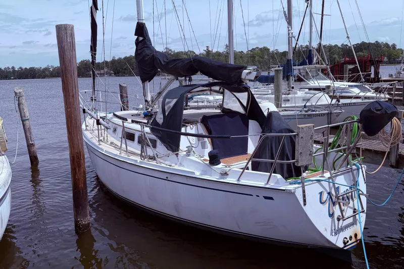 Slide: The Image of 1981 CAL 31 sailboat docked at marina. - 11