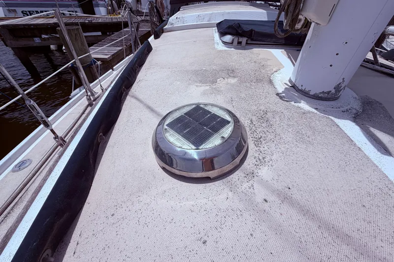 Slide: The Image of 1981 CAL 31 sailboat deck with solar vent, docked at marina. - 12