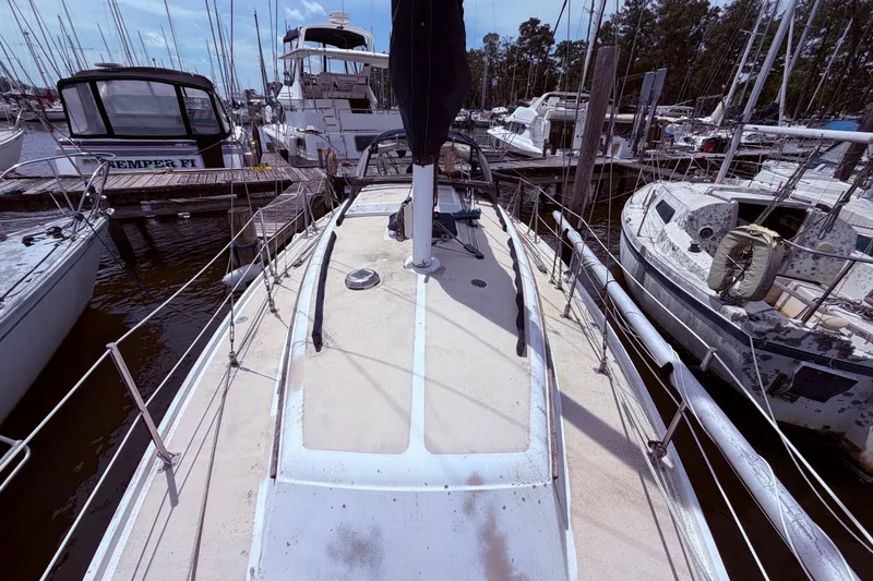 Slide: The Image of 1981 CAL 31 sailboat docked at marina, surrounded by other boats. - 13