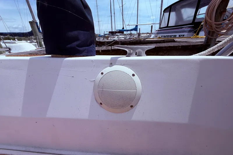 Slide: The Image of 1981 CAL 31 sailboat deck with speaker and cleat in marina setting. - 16