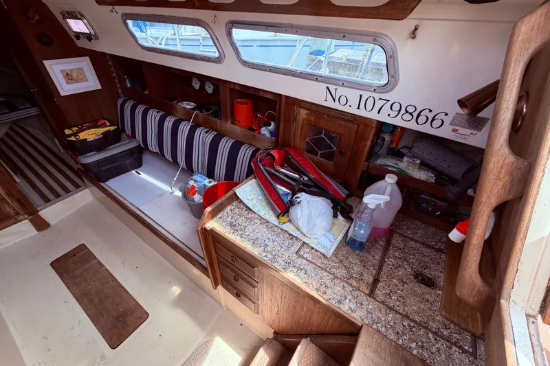 Slide: The Image of Interior of 1981 CAL 31 sailboat with striped seating and storage compartments. - 19