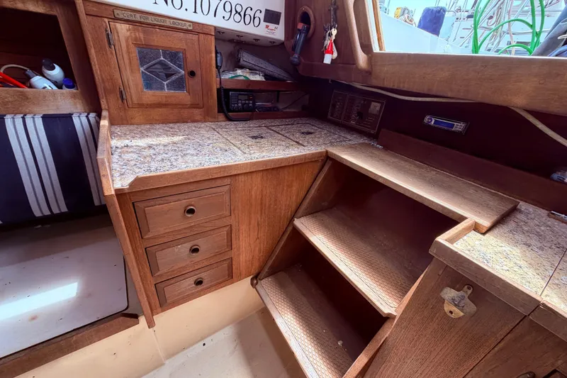 Slide: The Image of Interior of a 1981 CAL 31 sailboat featuring wooden cabinetry and steps. - 22