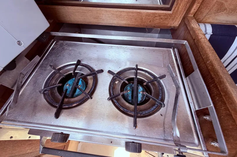 Slide: The Image of Two-burner stainless steel stove in a 1981 CAL 31 boat galley. - 25
