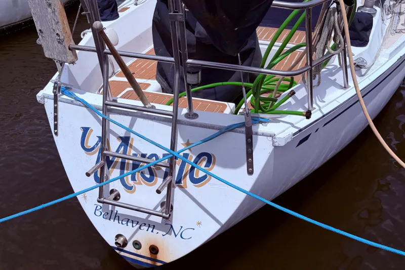 Slide: The Image of 1981 CAL 31 sailboat docked, featuring a ladder and ropes, labeled "Belhaven, NC." - 4