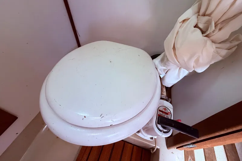 Slide: The Image of 1981 CAL 31 boat toilet with manual pump handle in compact bathroom space. - 41