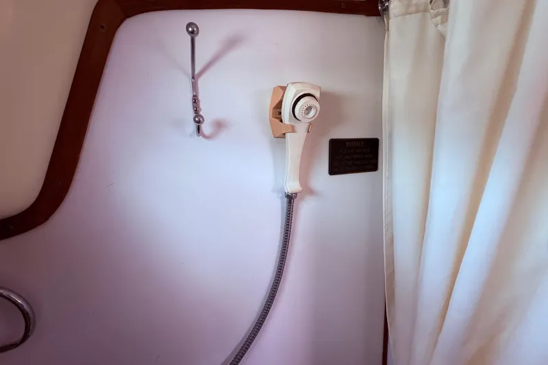 Slide: The Image of Shower area in 1981 CAL 31 boat with curtain and handheld showerhead. - 42