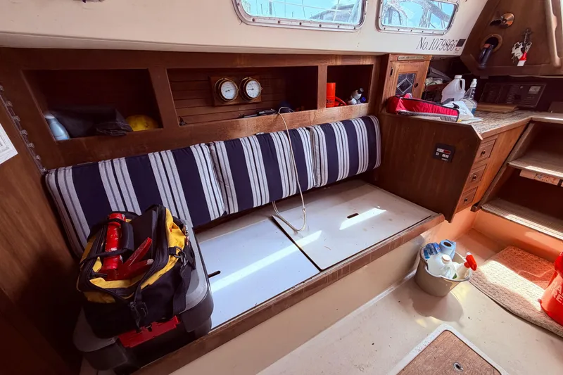 Slide: The Image of Interior of a 1981 CAL 31 sailboat with striped seating and nautical equipment. - 44