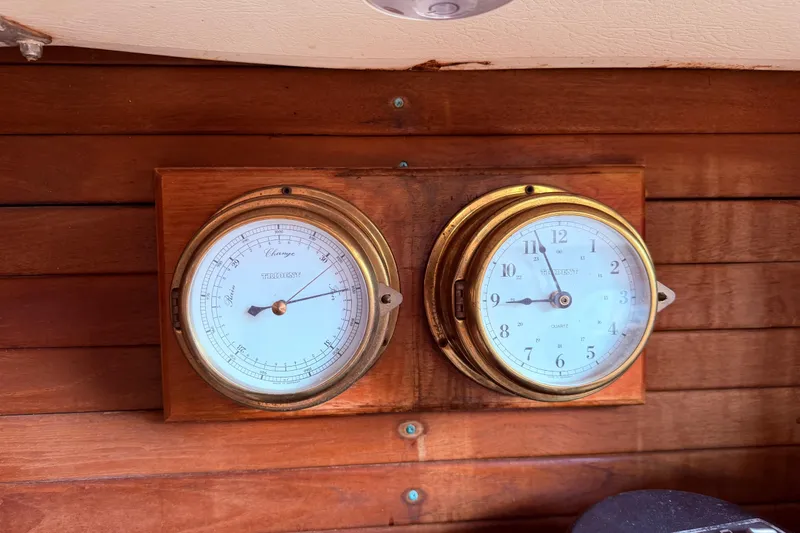 Slide: The Image of Vintage brass barometer and clock on wooden CAL 31 sailboat interior, 1981 model. - 47