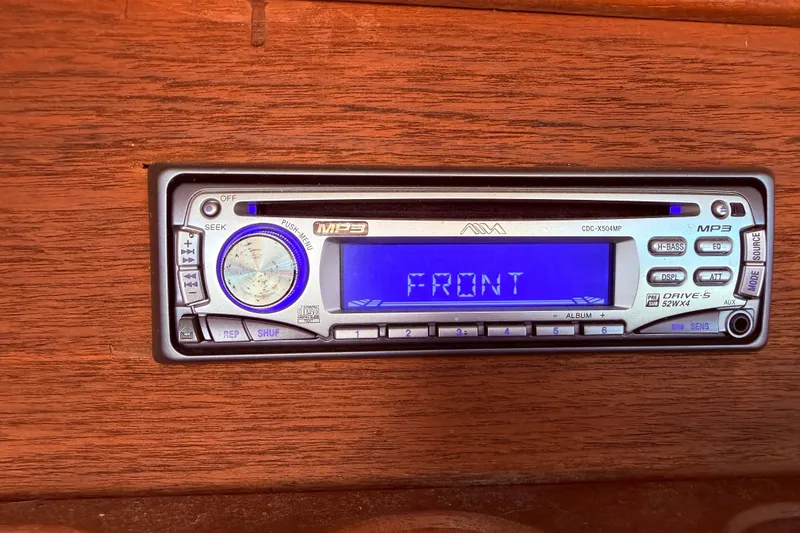 Slide: The Image of Vintage car stereo system with digital display, mounted on wooden dashboard. - 48