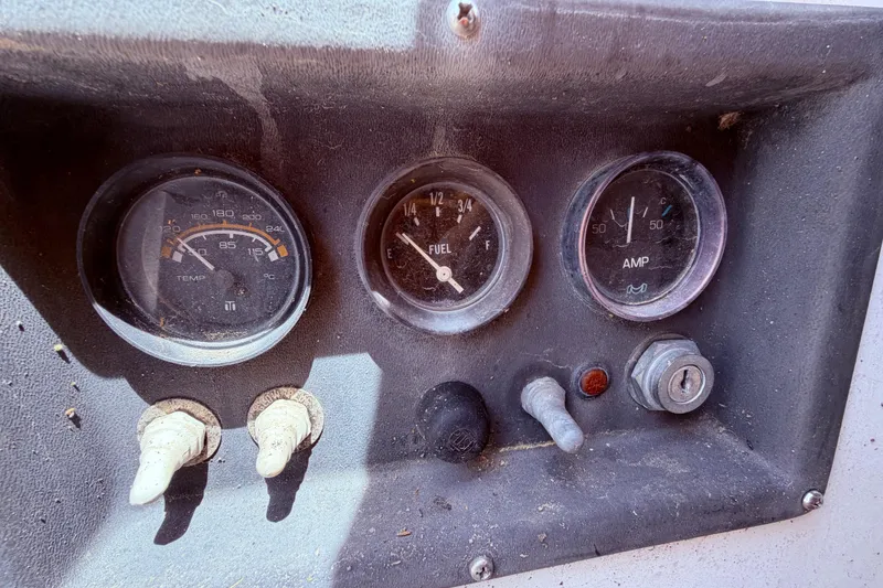 Slide: The Image of Instrument panel of a 1981 CAL 31 boat with temperature, fuel, and amp gauges. - 5