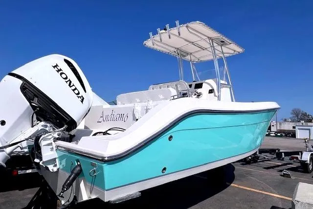 Slide: The Image of 2021 Cobia 237 Center Console boat with Honda outboard motor. - 1