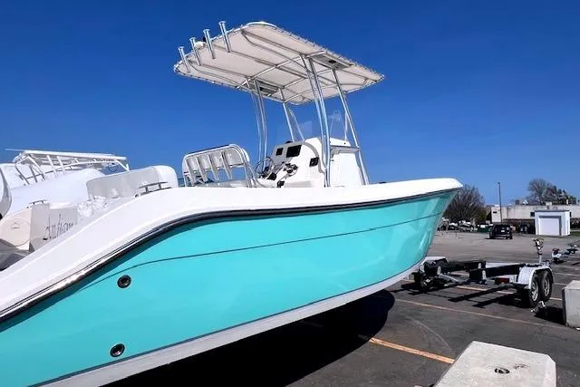 Slide: The Image of 2021 Cobia 237 Center Console boat on trailer, turquoise. - 2
