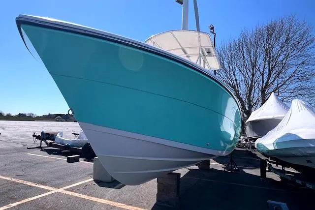 Slide: The Image of 2021 Cobia 237 Center Console boat in a parking lot. - 4