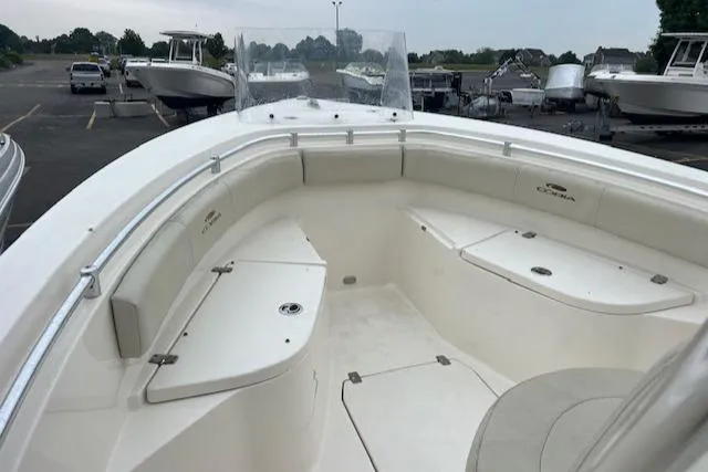 Slide: The Image of 2021 Cobia 237 Center Console boat, spacious deck, parked in a marina. - 5