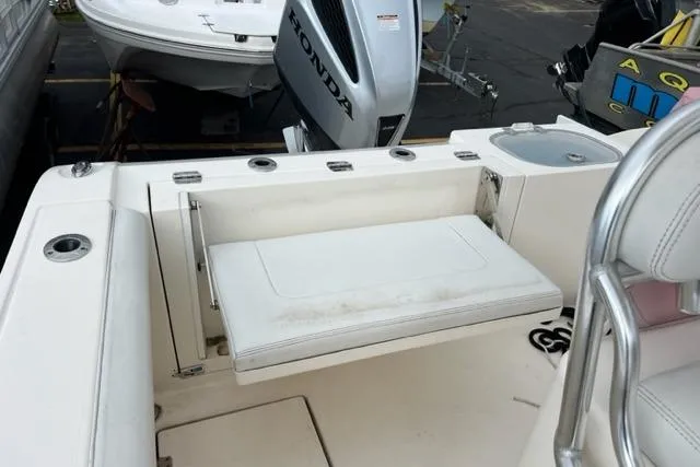 Slide: The Image of 2021 Cobia 237 Center Console boat with Honda outboard motor and foldable seating. - 8