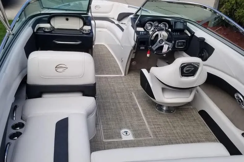 Slide: The Image of 2016 Crownline 225 SS boat interior with plush seating and modern dashboard. - 4